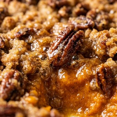 Ultra close-up macro of baked sweet potato casserole with pecan streusel