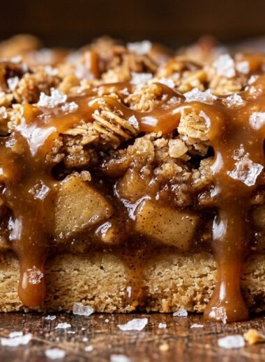Ultra close-up macro of salted caramel apple crisp bars with buttery shortbread and dripping caramel